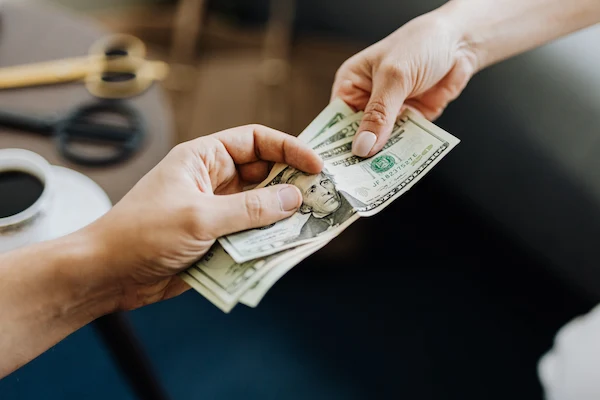 person handing over money